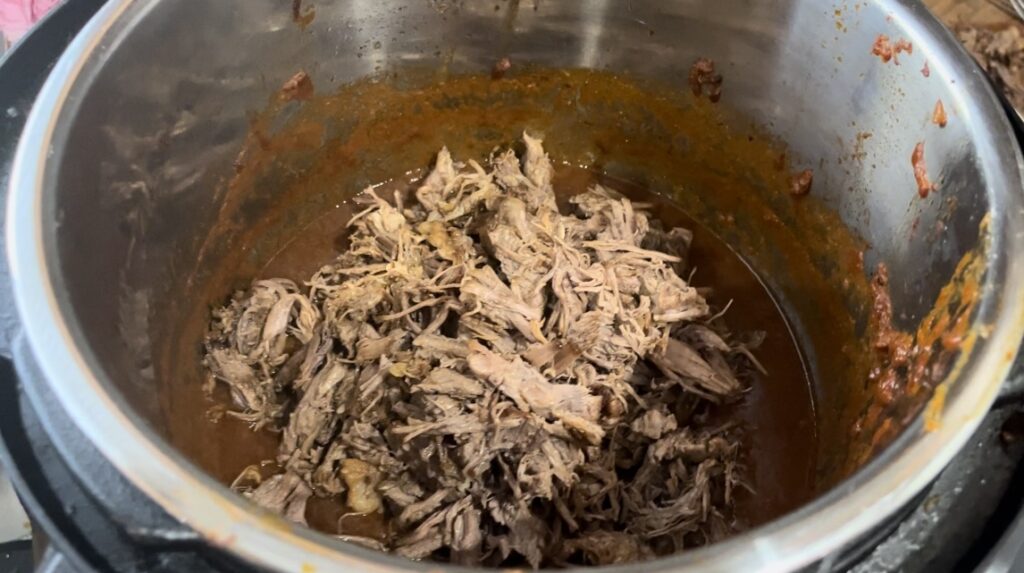 close up of shredded chuck roast in instant pot