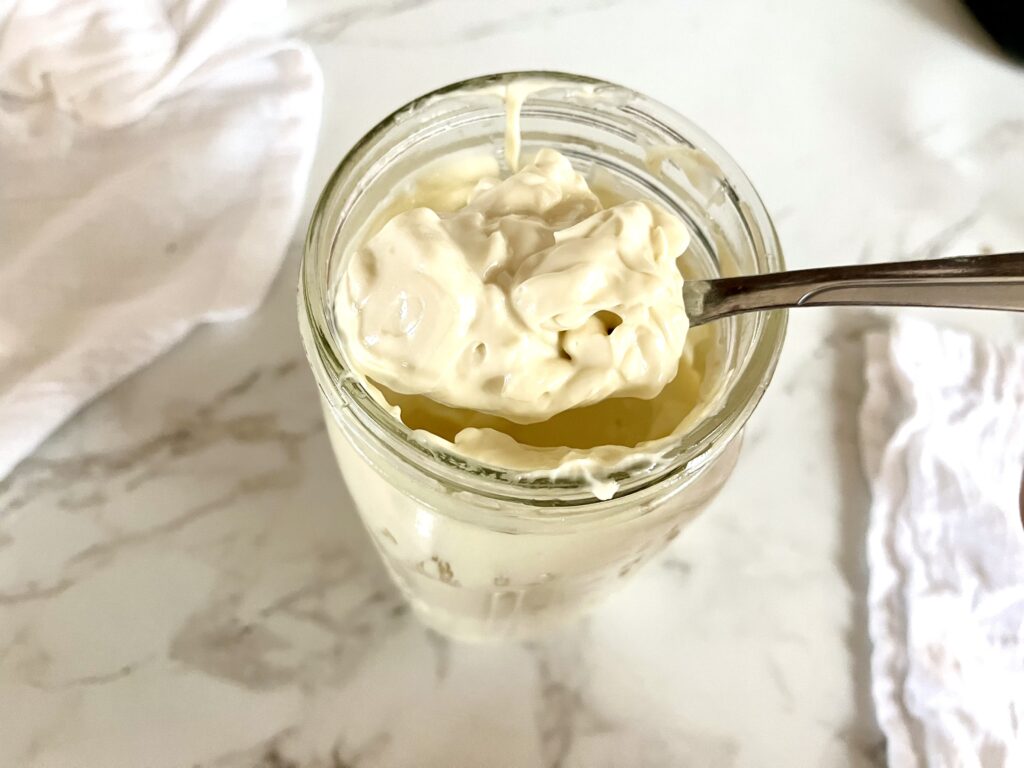 close up of spoon scooping mayo out of a jar