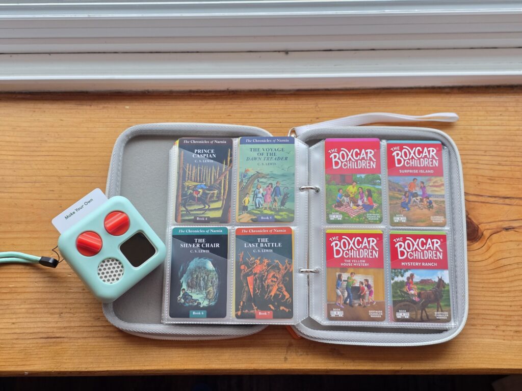yoto player next to small binder holding 8 yoto cards